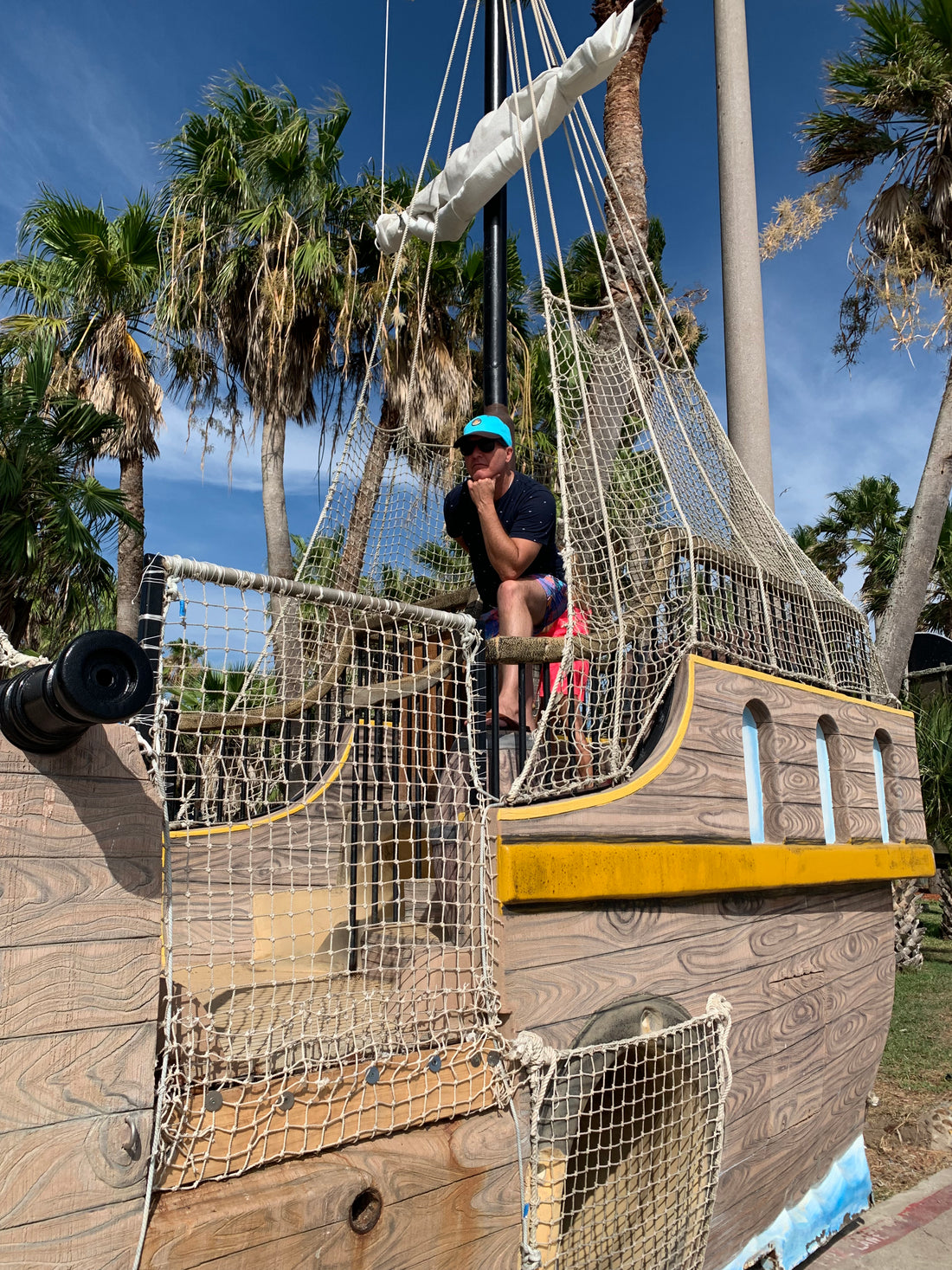 Coastal Vibes Dad Hat on man standing on pirate ship