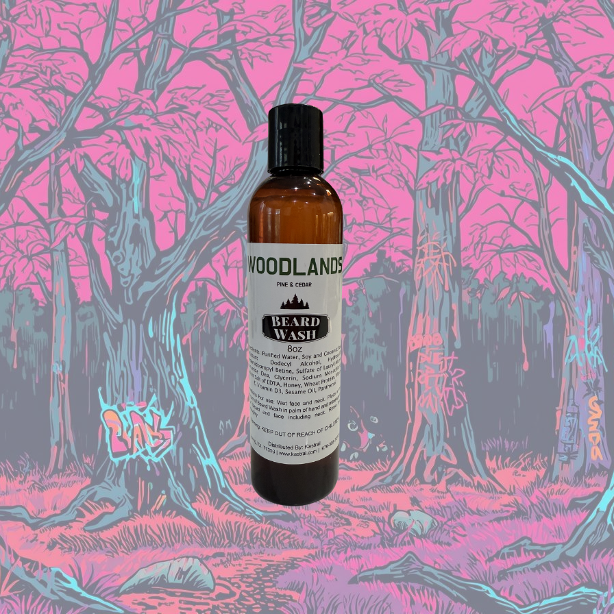 Bottle of Woodland Beard Wash by Kastral with a colorful, stylized forest background.